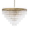 A glamorous art deco chandelier with brass accents by Eichholtz