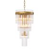 The Yara Chandelier, with clear glass tubes arranged in a stunning waterfall effect on an antique brass frame, offers adjustable height for a custom touch.
