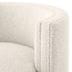 A glamorous boucle cream armchair with a brass swivel base