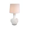 A stylish table lamp by Eichholtz with a white porcelain base featuring relief patterns, a crystal glass plinth and off-white fabric shade