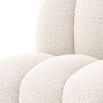 A luxurious dining chair by Eichholtz with a bouclé cream upholstery and deep channel stitching
