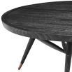 A sophisticated coffee table from Eichholtz with a wooden structure, charcoal grey veneer finish and tapered legs with antique brass feet