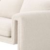 A unique and distinctive sofa by Eichholtz with a bouclé cream upholstery and free flowing shape