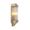 A vintage and art deco inspired wall lamp in a brass finish adorned with glass rods.