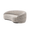 Curved sofa upholstered in a beige fabric.