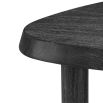 A rounded triangular coffee table with a charcoal veneer finish