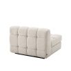Middle sofa section upholstered in a boucle cream fabric with a black base.