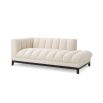 A luxurious left facing sofa from Eichholtz with a beautiful boucle cream upholstery and contrasting black base