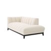 A luxurious left facing sofa from Eichholtz with a beautiful boucle cream upholstery and contrasting black base