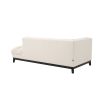 A luxurious left facing sofa from Eichholtz with a beautiful boucle cream upholstery and contrasting black base