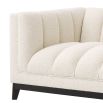 A luxurious left facing sofa from Eichholtz with a beautiful boucle cream upholstery and contrasting black base