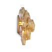 A statement wall lamp by Eichholtz with diamond-shaped, amber glass tubes and an antique brass finish