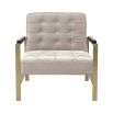 A luxurious natural-toned armchair with a brushed brass frame, defining piping and deep buttoning  