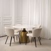 A glamorous Dining Table by Eichholtz with a round white ceramic marble top and tapered brushed brass base