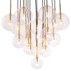 A luxury statement chandelier by Eichholtz with twelve hanging, clear glass spheres and an antique brass finish
