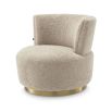 A luxuriously soft curvaceous swivel chair by Eichholtz with a brushed brass swivel base