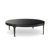 A sophisticated coffee table by Eichholtz with a round black bevelled glass top, bronze frame and brass accents on it's tapered feet