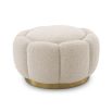 A stunning floral inspired ottoman with a curvilinear shape, a glamorous brushed brass swivel base and a luxurious boucle cream upholstery with deep channel stitching