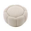 A stunning floral inspired ottoman with a curvilinear shape, a glamorous brushed brass swivel base and a luxurious boucle cream upholstery with deep channel stitching