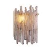 A wall lamp with icicle styled smoked glass and a light brass finish.