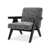 A luxurious chair by Eichholtz with a Cambon Black upholstery and black V-shaped legs