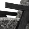 A luxurious chair by Eichholtz with a Cambon Black upholstery and black V-shaped legs