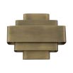 A statement, Art-Deco wall lamp with a vintage brass finish 