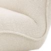 A beautiful, boucle cream upholstered chair by Eichholtz with a brushed brass base 