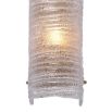 A gorgeous wall lamp by Eichholtz with a modern design and vintage brass finish with a ribbed clear glass shade