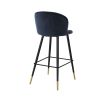 Luxurious blue velvet bar stool with black tapered legs and brass caps