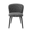 A divine dining chair by Eichholtz with a chic Cambon Black upholstery, sleek black tapered legs and an alluring arched back