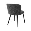 A divine dining chair by Eichholtz with a chic Cambon Black upholstery, sleek black tapered legs and an alluring arched back