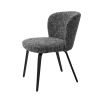 A divine dining chair by Eichholtz with a chic Cambon Black upholstery, sleek black tapered legs and an alluring arched back