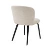 A gorgeous dining chair by Eichholtz with an arched back, tapered black legs and a Pausa Natural upholstery