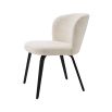 A gorgeous dining chair by Eichholtz with an arched back, tapered black legs and a Pausa Natural upholstery