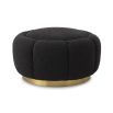A fabulous floral inspired ottoman featuring a curvilinear shape, a beautiful boucle black upholstery, deep channel stitching and a glamorous brushed brass swivel base