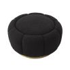 A fabulous floral inspired ottoman featuring a curvilinear shape, a beautiful boucle black upholstery, deep channel stitching and a glamorous brushed brass swivel base