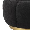 A fabulous floral inspired ottoman featuring a curvilinear shape, a beautiful boucle black upholstery, deep channel stitching and a glamorous brushed brass swivel base