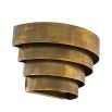 A statement wall lamp by Eichholtz with a vintage brass finish
