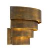 A statement wall lamp by Eichholtz with a vintage brass finish