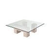 Graceful and sophisticated modern coffee table with glass surface and travertine base