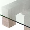 Graceful and sophisticated modern coffee table with glass surface and travertine base