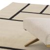 Off-white and black geometric patterned rug made from New Zealand wool.