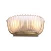 A luxurious wall lamp by Eichholtz featuring a frosted glass shade with vertical lines and a vintage brass finish