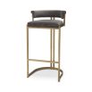 Art Deco inspired bar stool with a brushed brass frame and a grey velvet seat.