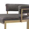 Art Deco inspired bar stool with a brushed brass frame and a grey velvet seat.