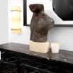 A statement torso sculpture by Eichholtz with an antique bronze finish and marble base