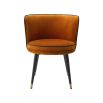 A luxurious orange velvet dining chair with a swivel seat, black legs and gold capped feet 