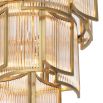 A luxurious chandelier by Eichholtz with a curved antique brass finish and decorative clear glass rods