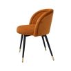 A luxury set of dining chairs with an orange velvet upholstery and golden capped feet
